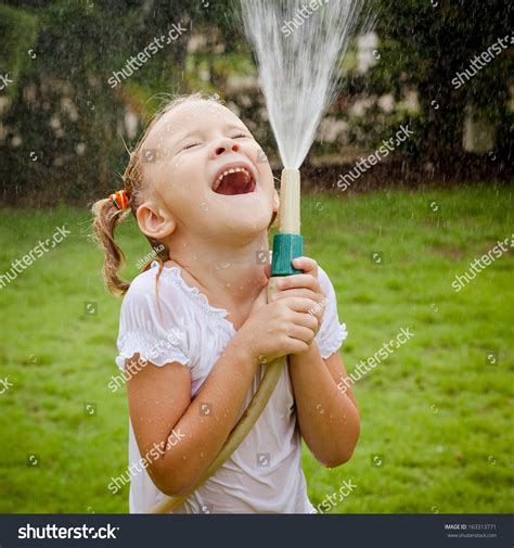 Happy Girl Pouring Water From A Hose Stock Photo 163313771 Shutterstock