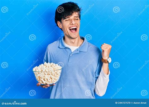 Handsome Hipster Young Man Eating Popcorn Screaming Proud Celebrating