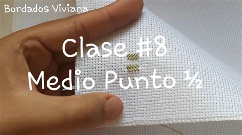 A Hand Is Holding A Piece Of White Fabric With The Words Class 8 Medio