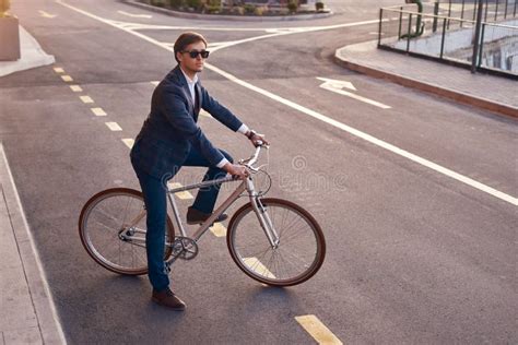 Modern Commuter In Business Suit Riding Bike In City Stock Image