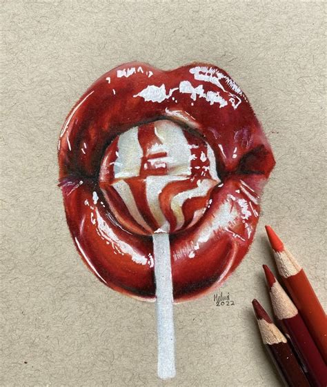 A Drawing Of A Lollipop On Paper With Pencils Next To It