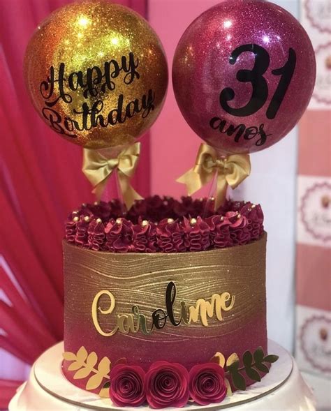 A Birthday Cake With Two Balloons On Top