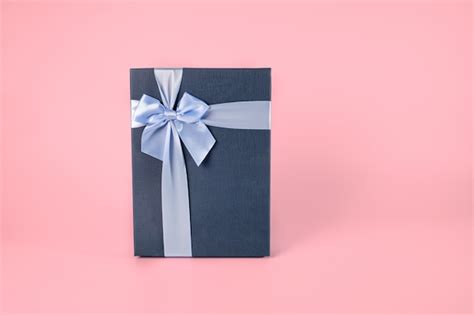 Premium Photo | Decorative dark blue gift box with light blue bow isolated on pink pastel ...