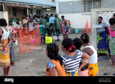 Health Workers Spray Peoples Feet Before Entering A Cholera Treatment