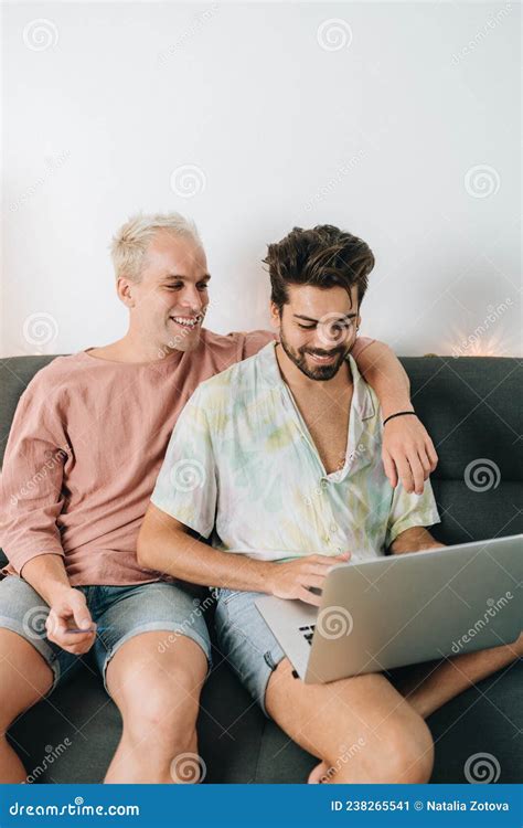 Gay Couple Sitting On Sofa With Laptop Stock Image Image Of Bank
