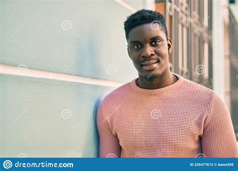 Young African American Man Smiling Happy Standing At The City Stock