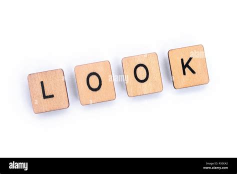 The Word Look Spelt With Wooden Letter Tiles Over A Plain White