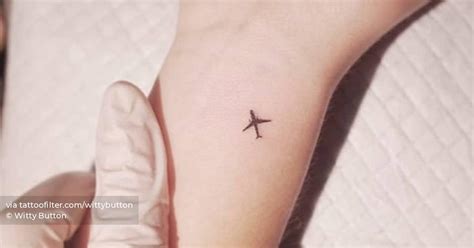 Minimalist Airplane Tattoo On The Wrist