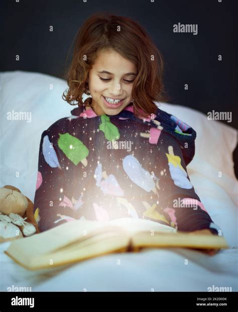 The Story Comes To Life Cropped Shot Of A Girl Reading A Book In Bed