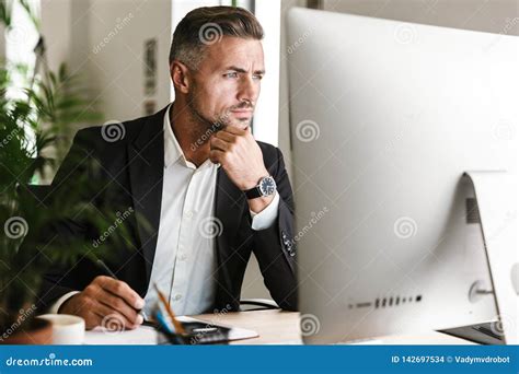 Image Of Confident Businessman Working In Office And Looking On