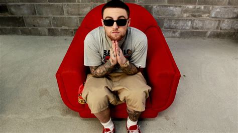 Mac Miller Is Sitting On A Red Couch Wearing Cap And Goggles 4 Hd