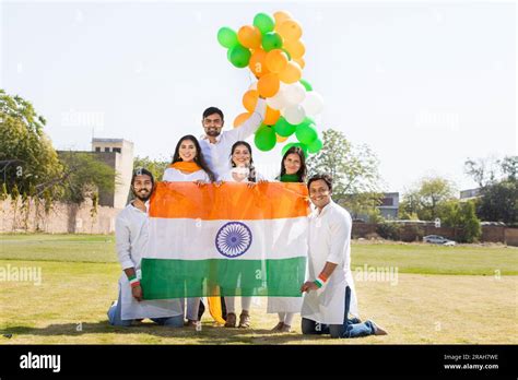 Group of happy young people wearing traditional white dress holding ...