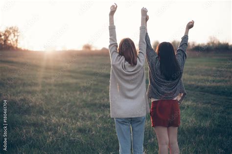 Two Best Friends Holding Hands In The Sunset