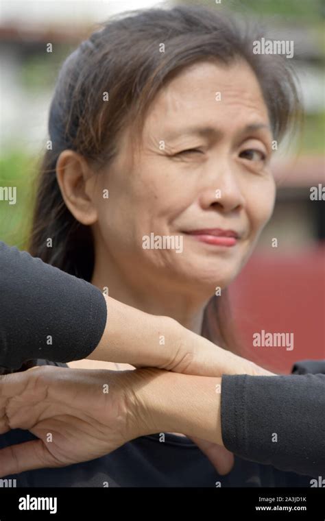 A Winking Retired Filipina Female Senior Stock Photo Alamy