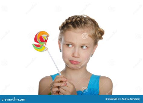 A Broken Lollipop On A Blue Background With A White Plastic Handle