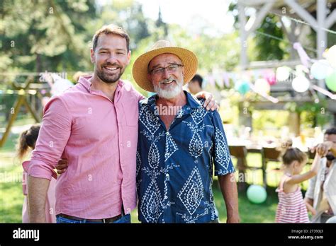 Mature Son With His Elderly Father At A Summer Garden Party Outdoors Concept Of Father S Day