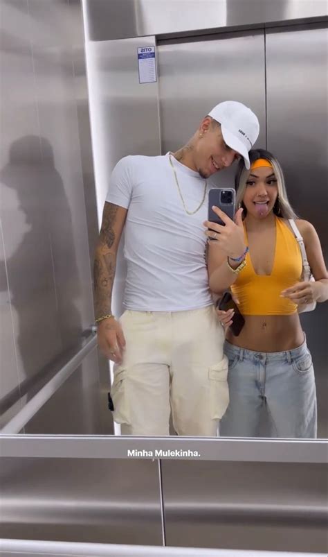 A Man And Woman Taking A Selfie In An Elevator