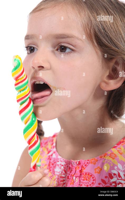 Little Girl Eating A Lollipop Stock Photo Alamy