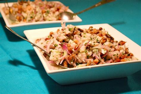 Two White Plates Filled With Food On Top Of A Blue Table