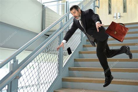 Senior Businessman Falling On Stairs Stock Photo By ©ginosphotos1 125201192