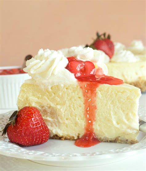 A Slice Of Cheesecake On A Plate With Strawberries