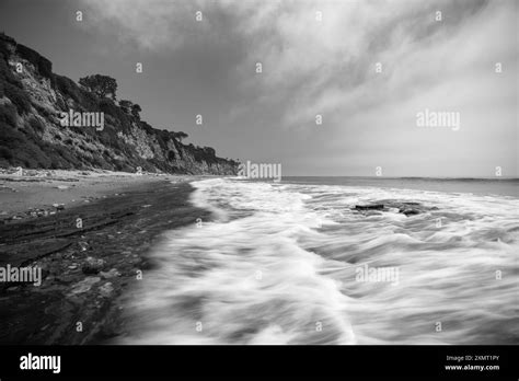Black And White View Of Dume Cove Beach With Motion Blur Water In
