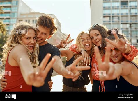 Peace Out Cropped Portrait Of A Group Of Young Friends Flashing Peace