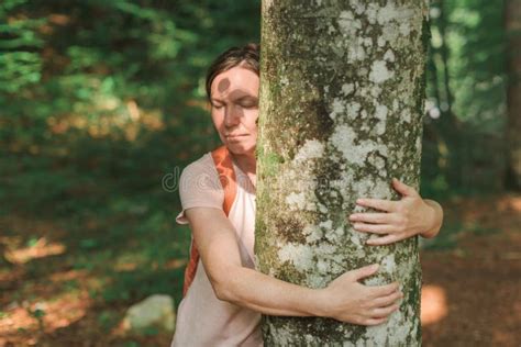 Environmentalist Tree Hugger Is Hugging Wood Trunk In Forest Stock