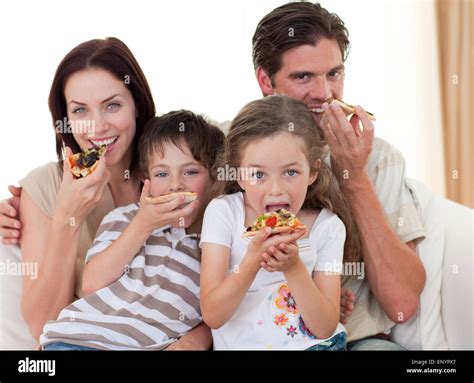 Happy family eating pizza Stock Photo - Alamy