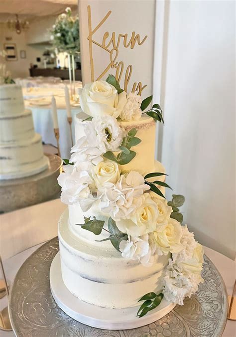 Semi Naked Wedding Cake With Cascading Ivory Roses The Cakery