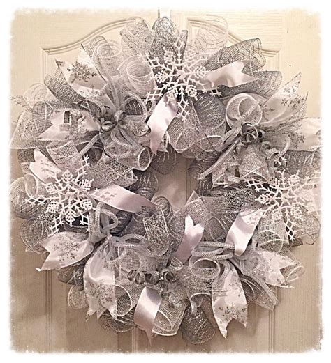 A Wreath Is Hanging On The Door With Silver Ribbons And Snowflakes