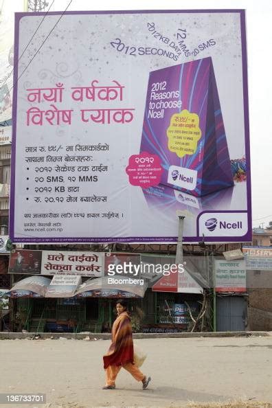 A Woman Walks Past A Billboard Advertisement For Ncell Pvt Ltd In News Photo Getty Images