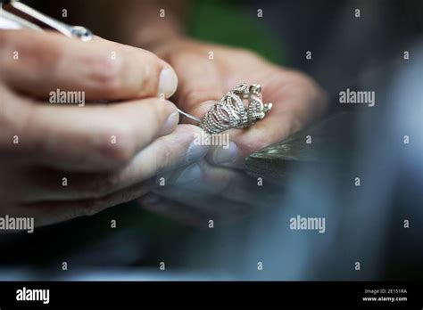 Jeweller Hands Working With Tools Bending And Polishing Golden Metal