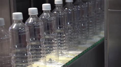 The Plastic Bottles Manufacturing Process By Blowing Machine Stock