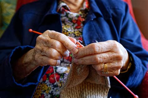 The Hands Of A 88 Year Old Grandmother Busy Knitting A Woolen Article