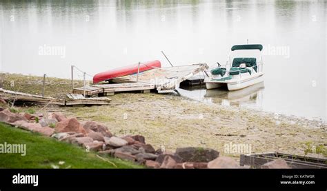 Wrecked Dock & Damaged Boat on Water After Storm Stock Photo - Alamy