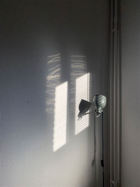 The Light Is Shining Through The Blinds In The Room