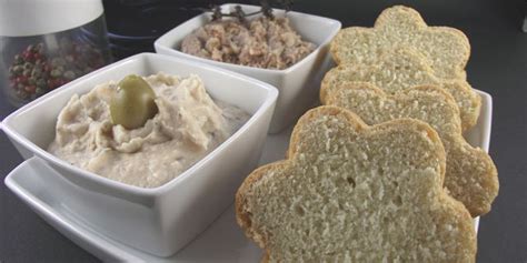 Several Small White Bowls Filled With Dips And Crackers On A Plate Next