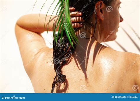 Naked Woman Straightens Her Hair Under Palm Branch Stock Photo Image