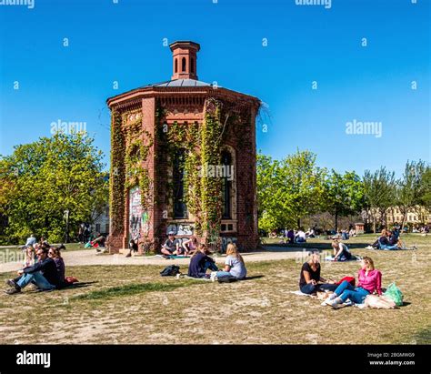 People Keep A Social Distance In The Park Of The The Water Tower During