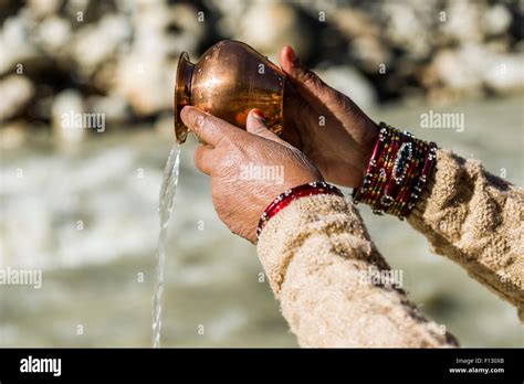 A Female Pilgrim Praying Offering The Holy Water At The Banks Of The