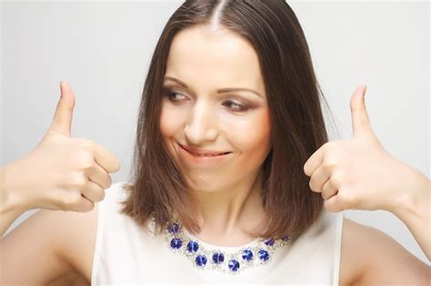 Premium Photo Successful Young Girl Gives Thumb Up With Two Hands