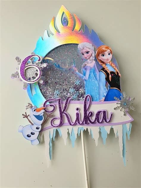 A Cake Topper With An Image Of Two Frozen Princesses And The Word Kika