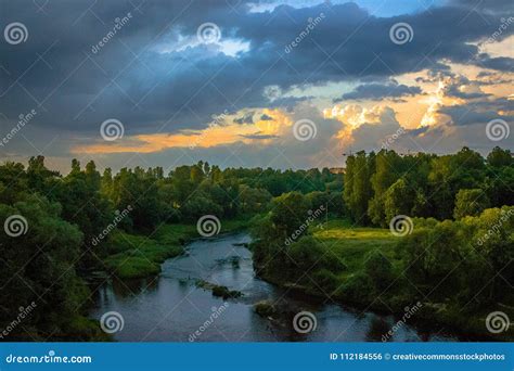 Photo Of River Between Green Grass Fields Picture Image 112184556