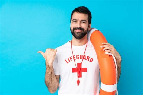 Premium Photo Lifeguard Man Pointing To The Side To Present A Product