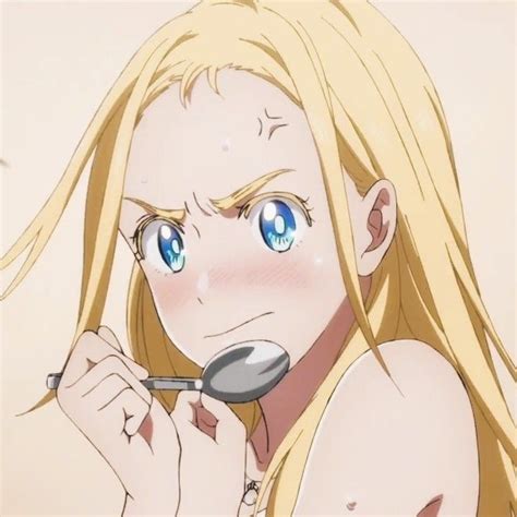 A Blonde Haired Woman Holding A Spoon In Front Of Her Face And Looking