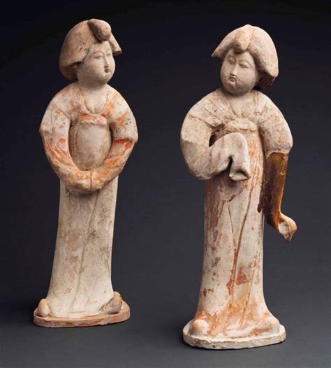 A PAIR OF PAINTED RED POTTERY FIGURES OF COURT LADIES