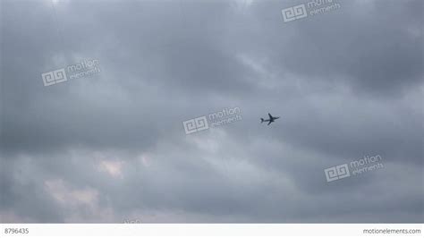 Distant Plane Crosses The Cloudy Sky Stock Video Footage 8796435