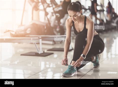 Pretty Woman Tying Shoelaces In A Gym Stock Photo Alamy