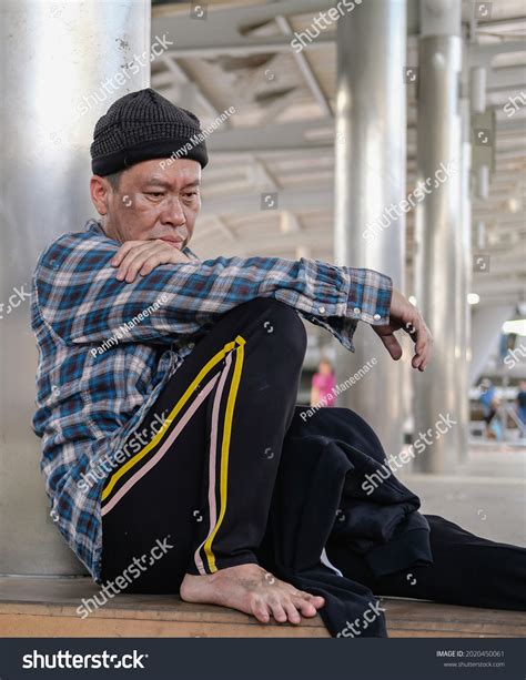 Stressed Asian Homeless Man Sitting Alone Stock Photo 2020450061